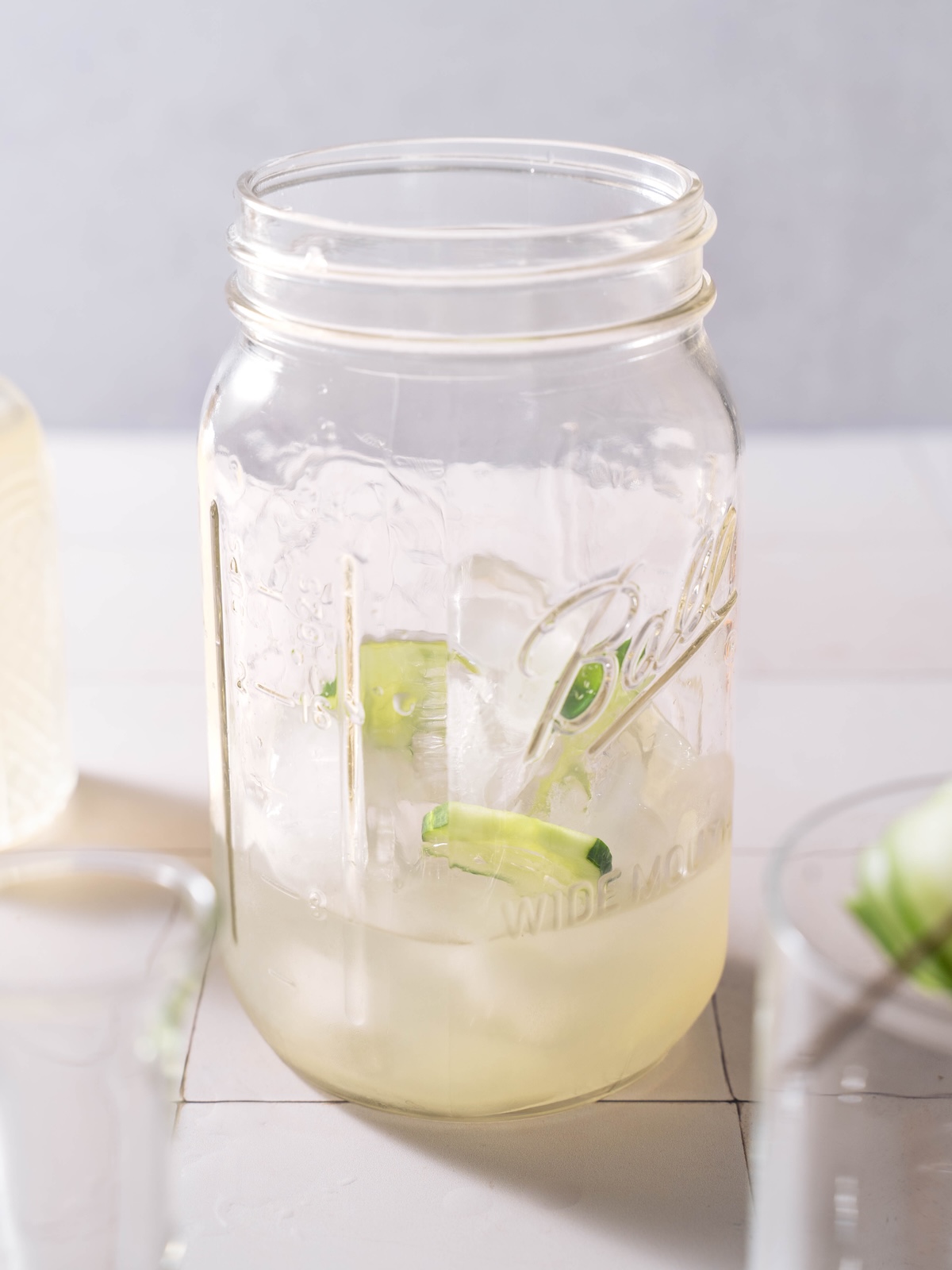 Ingredients for a White Linen cocktail mixed together in a glass jar