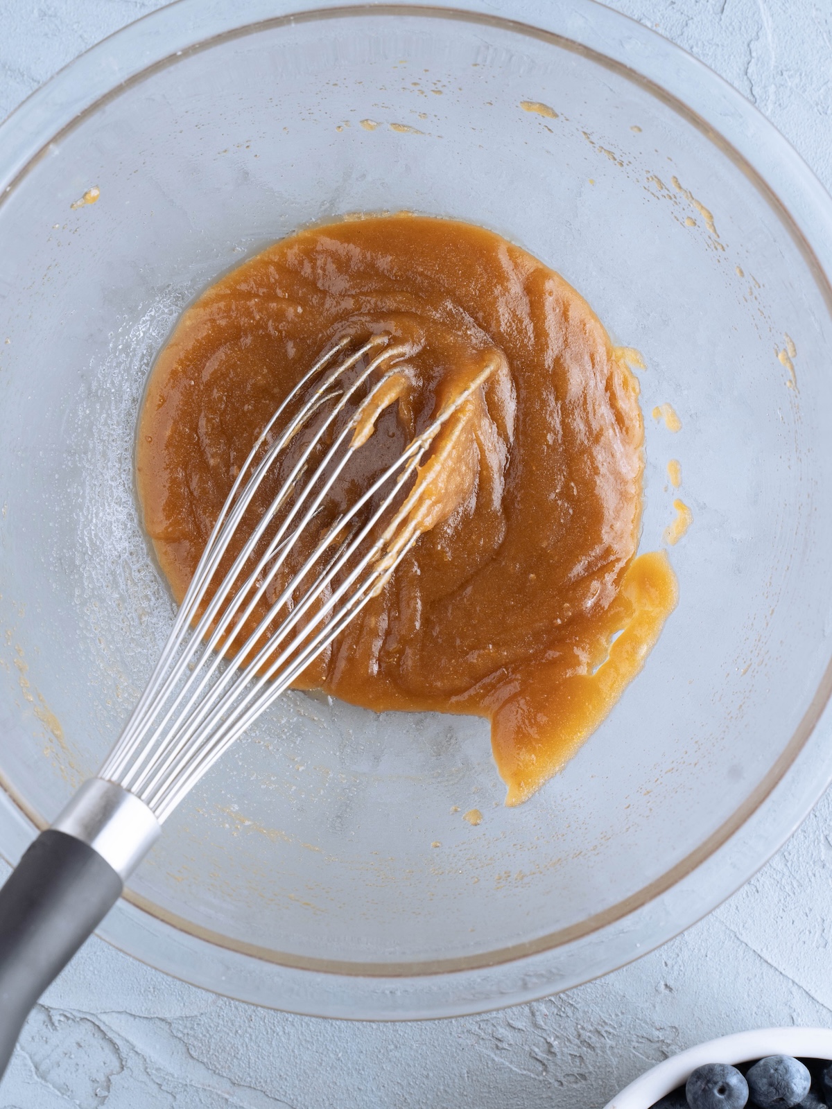 Whisking melted butter and brown sugar together to make bar cookies