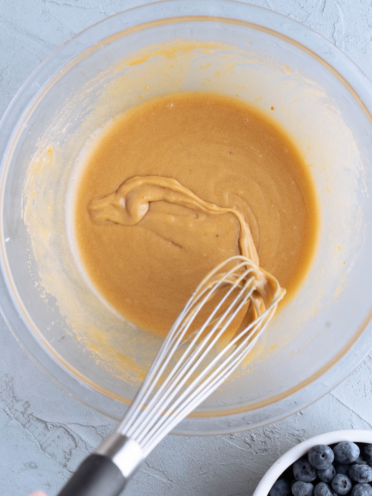 Whisking egg into butter and sugar mixture to make blondies