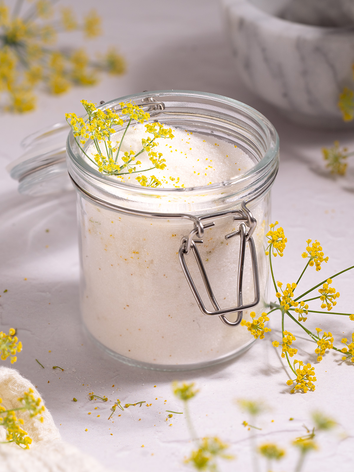 A jar full of sugar infused with fresh fennel pollen