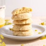 A stack of lemon and fennel pollen sugar cookies, surrounded by fennel flowers