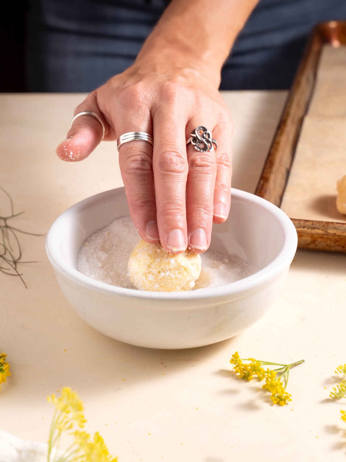 Rolling cookie dough in fennel pollen sugar