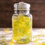 A jar full of vodka and fresh fennel flowers