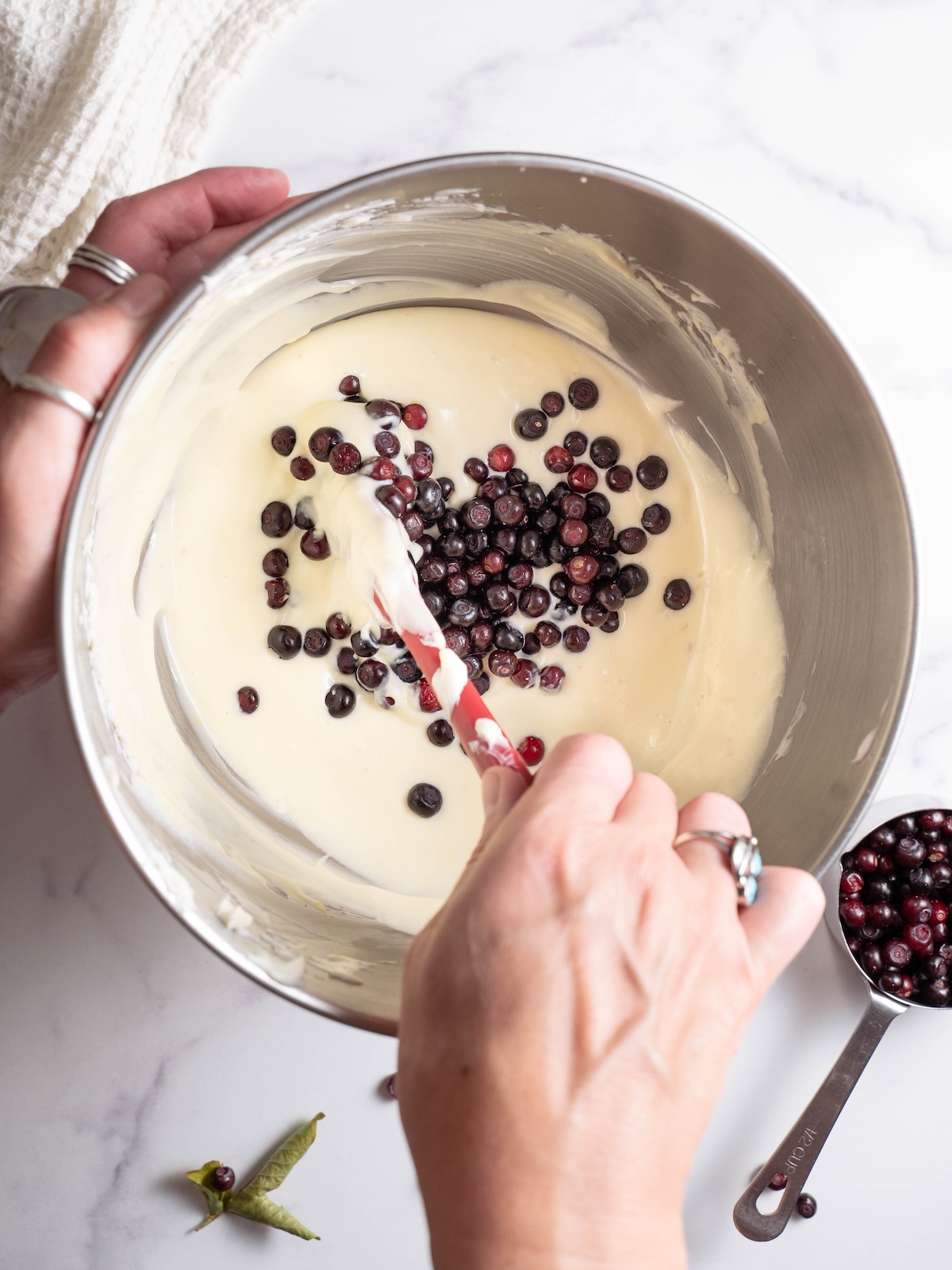 Folding wild huckleberries into cheesecake batter