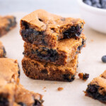 Three lemon blueberry blondies stacked on top of each other