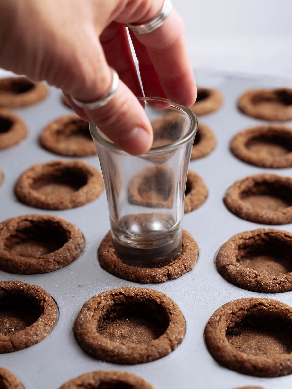 Indenting a freshly baked cookie to create a "cup"