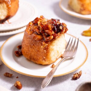 A plum sticky bun on a serving plate