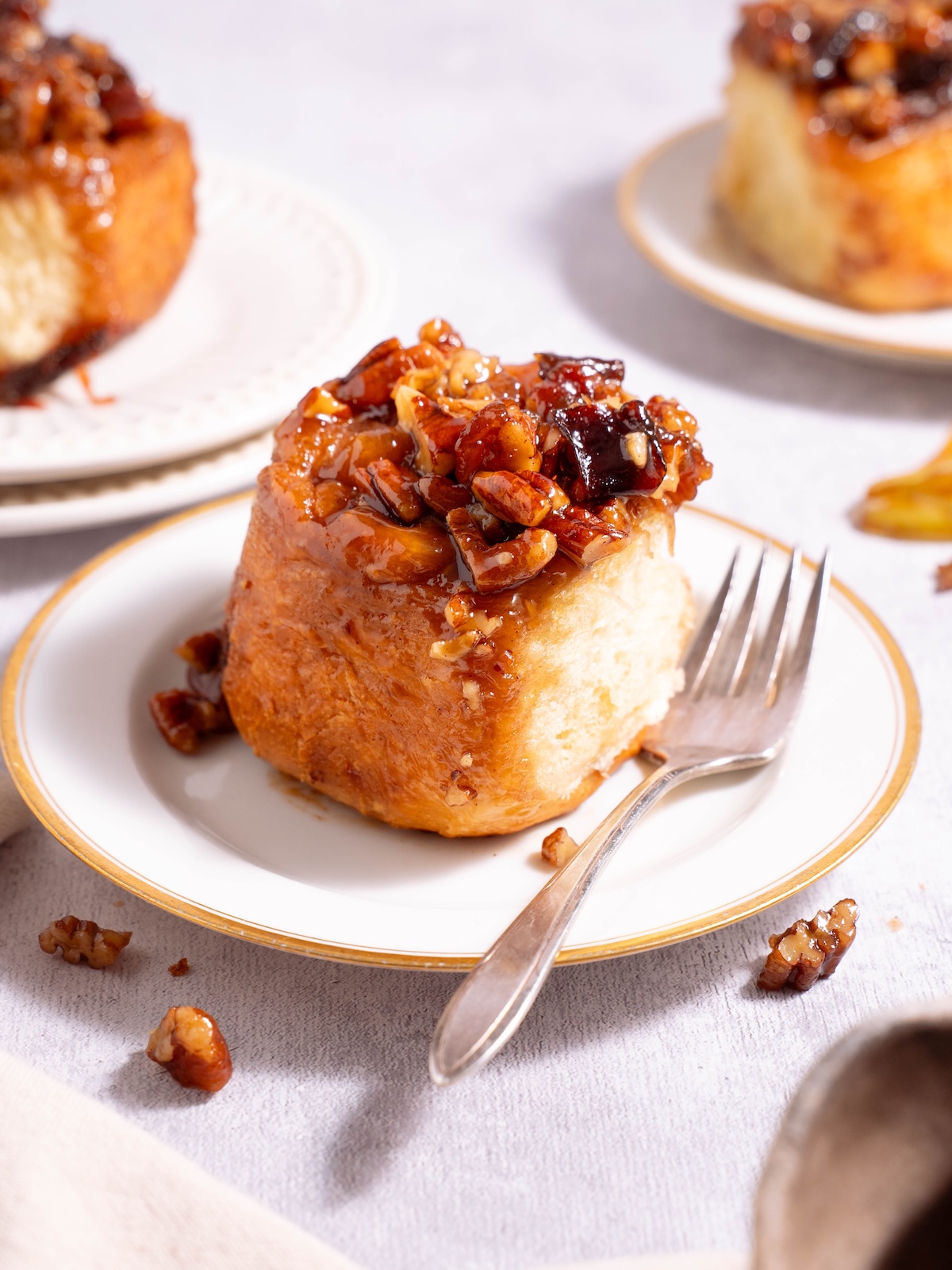 A plum sticky bun on a serving plate