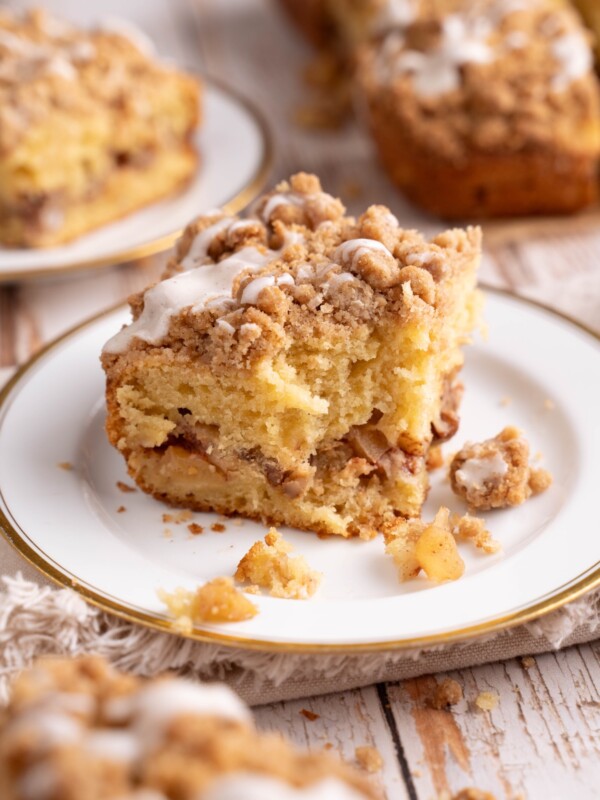 A slice of apple cinnamon coffee cake with a bite taken out of it