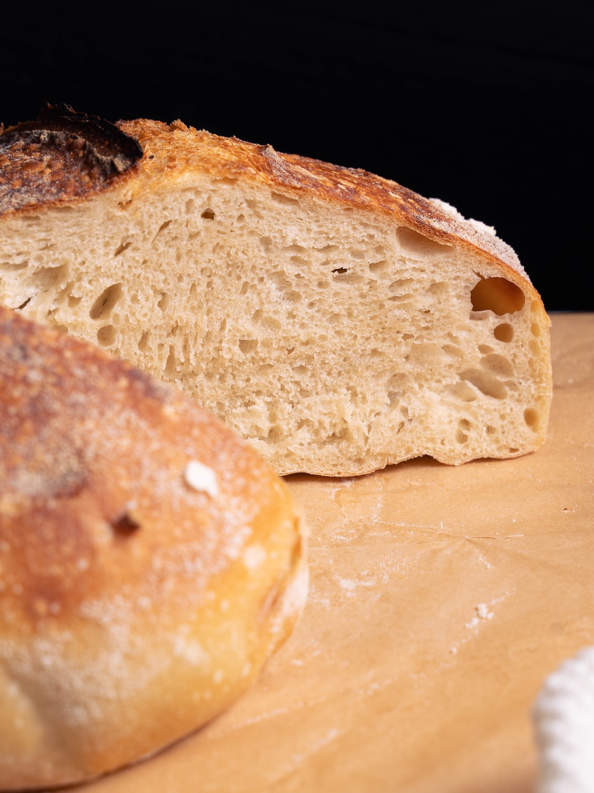 A loaf of homemade sourdough bread sliced in half to show interior
