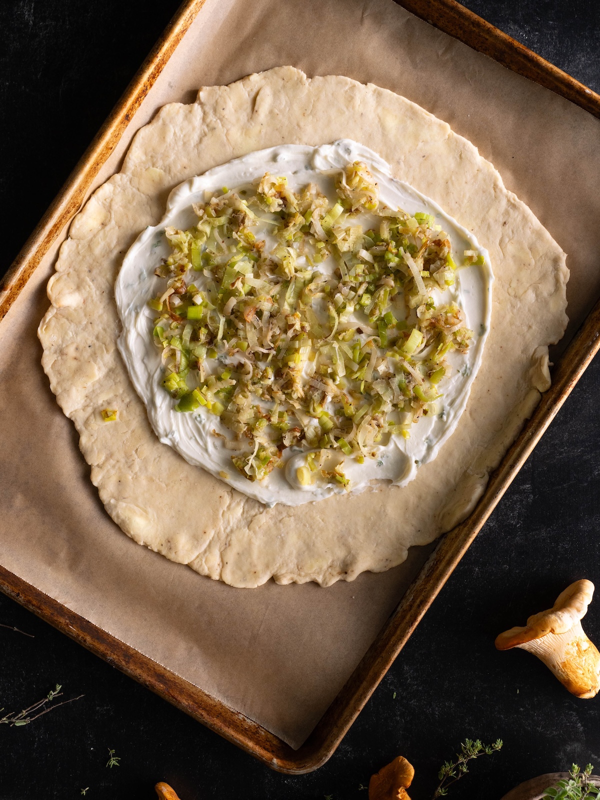 Goat cheese and buttered leeks at the base of a galette