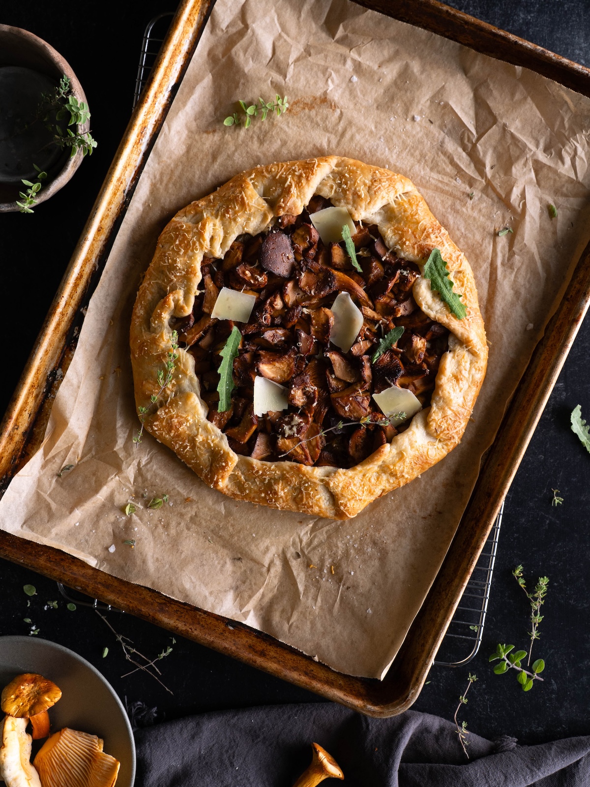 A wild mushroom galette, freshly baked on a sheet pan