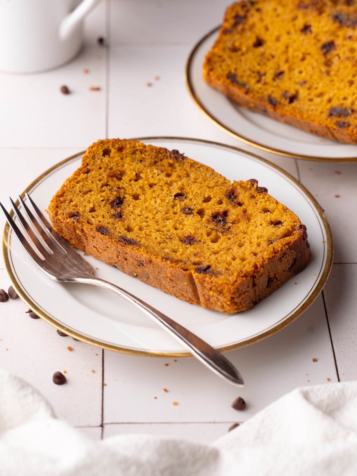 Slices of chocolate chip sourdough pumpkin bread on plates