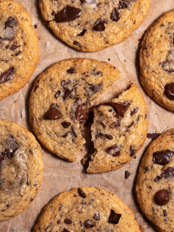 Closeup look at a melty brown butter sourdough chocolate chip cookie, broken in half