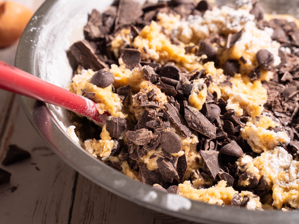 Various chocolates being mixed into cookie dough