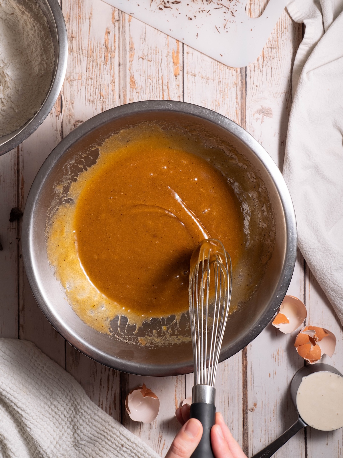 Brown sugar and butter being whisked to ribbon stage