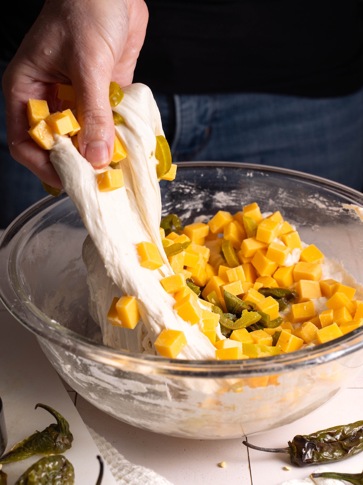 Folding cheese and pepper into sourdough