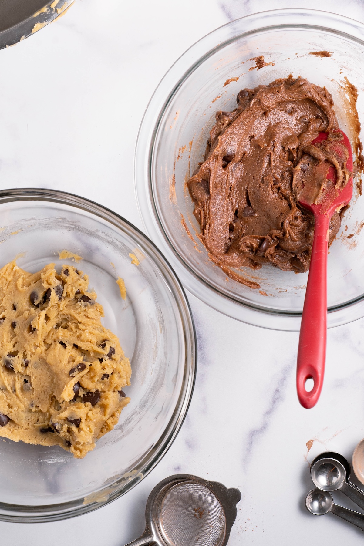 Chocolate and vanilla cookie dough mixed up in bowls