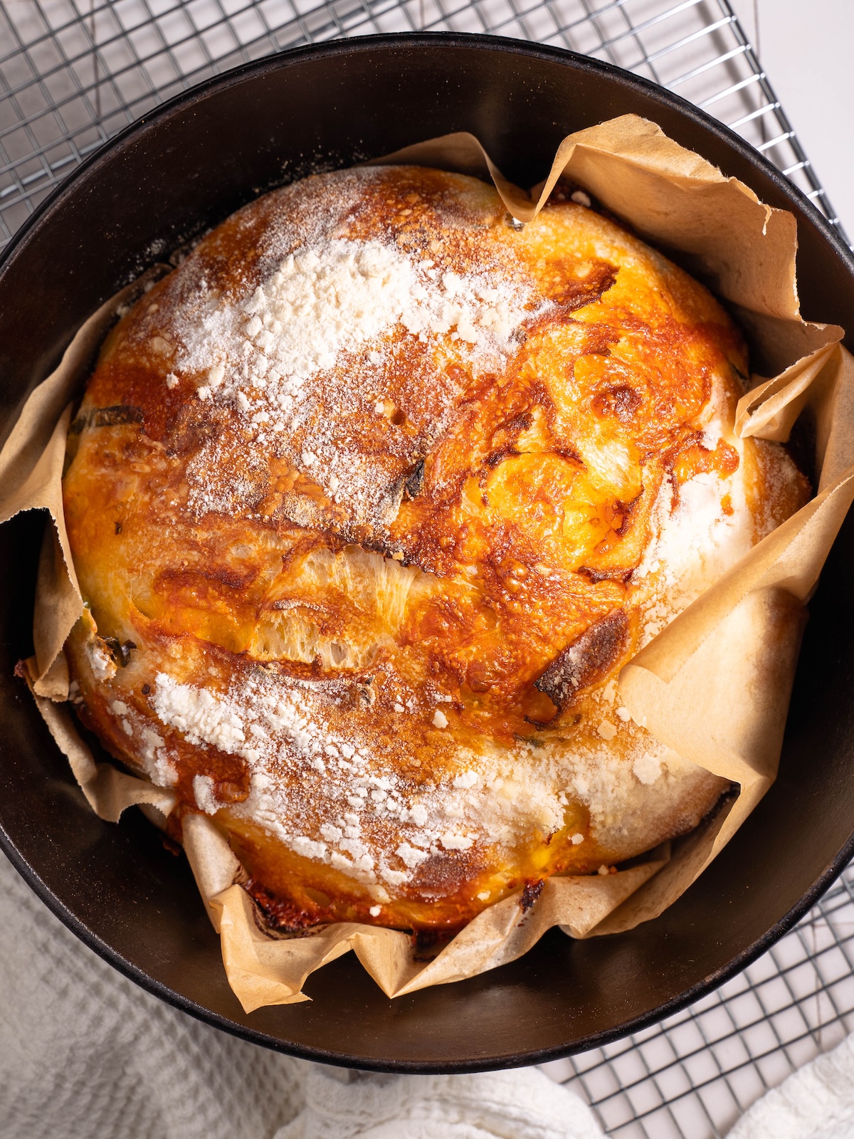 Freshly baked homemade sourdough boule in a Dutch oven