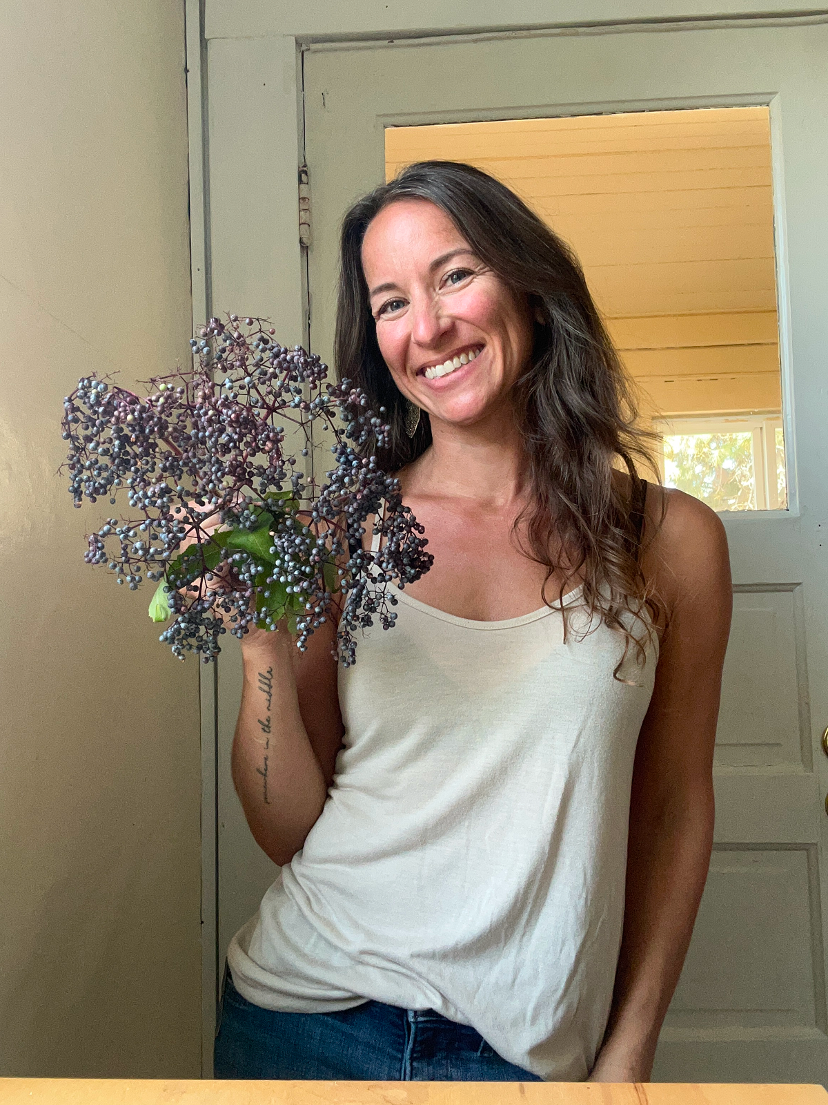Karie holding an umbel full of elderberries