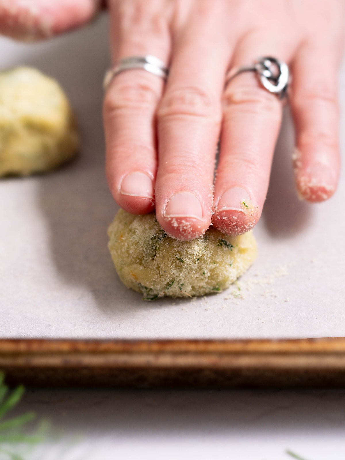 Hand flattening a Douglas fir cookie before baking