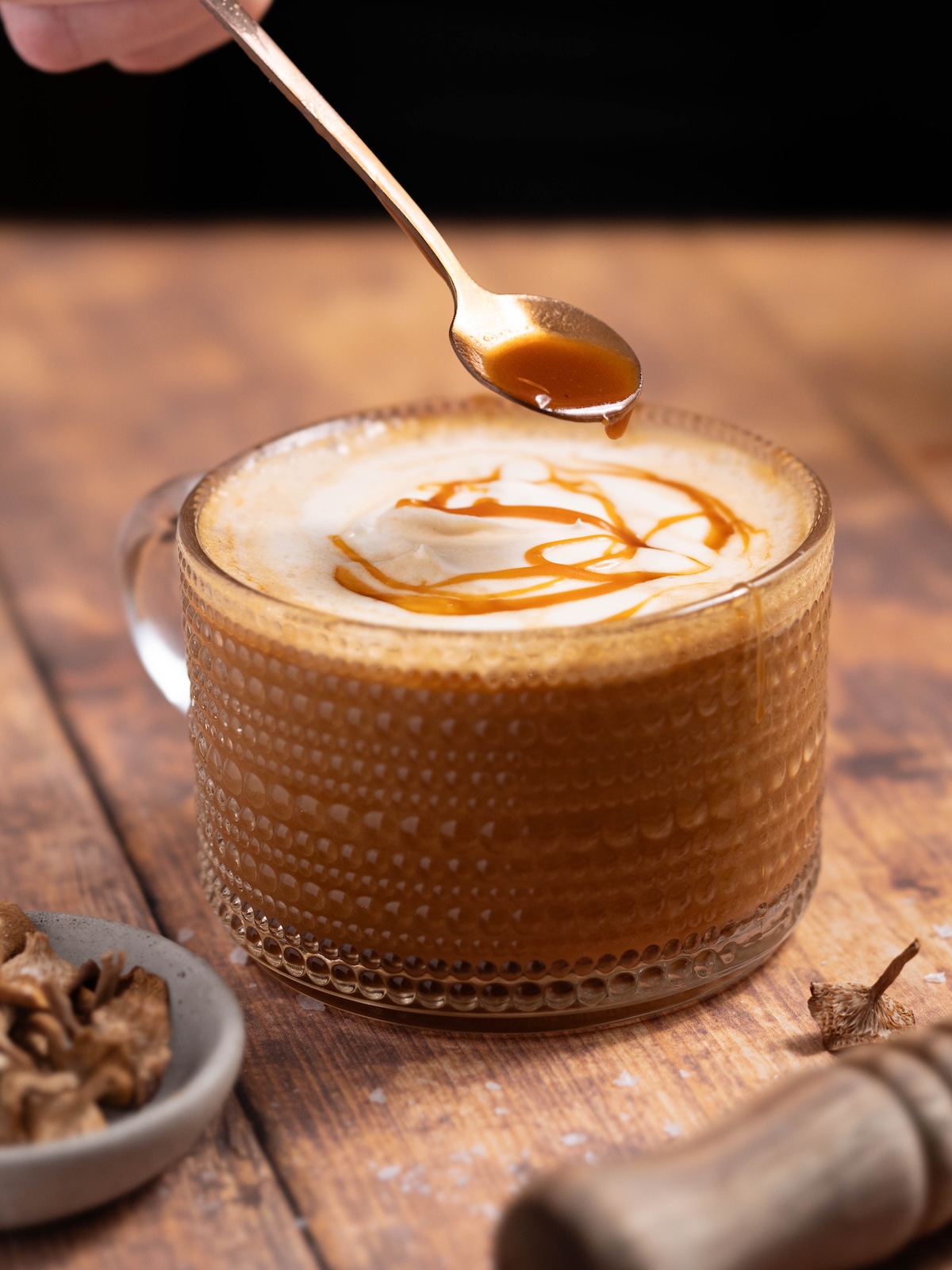 Drizzling candy cap caramel on top of a latte