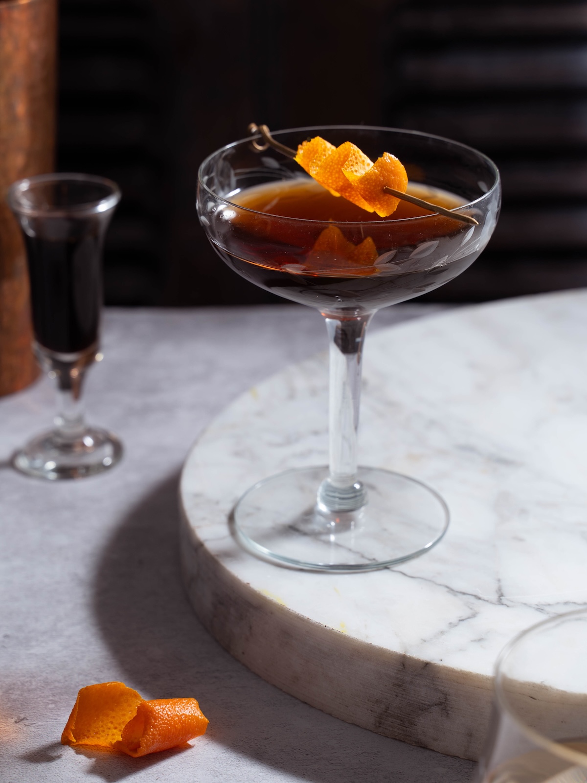 A nocino cocktail served up in a coupe glass