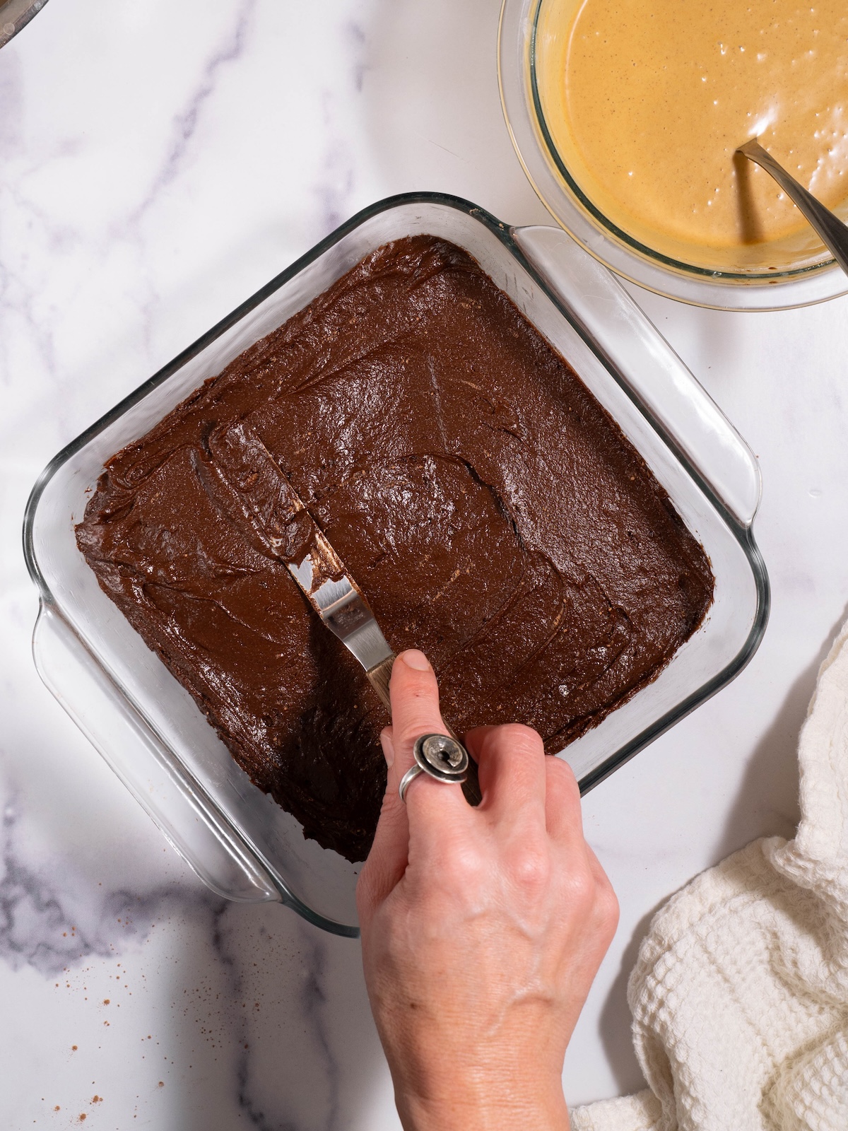 Spreading brownie batter in a square pan