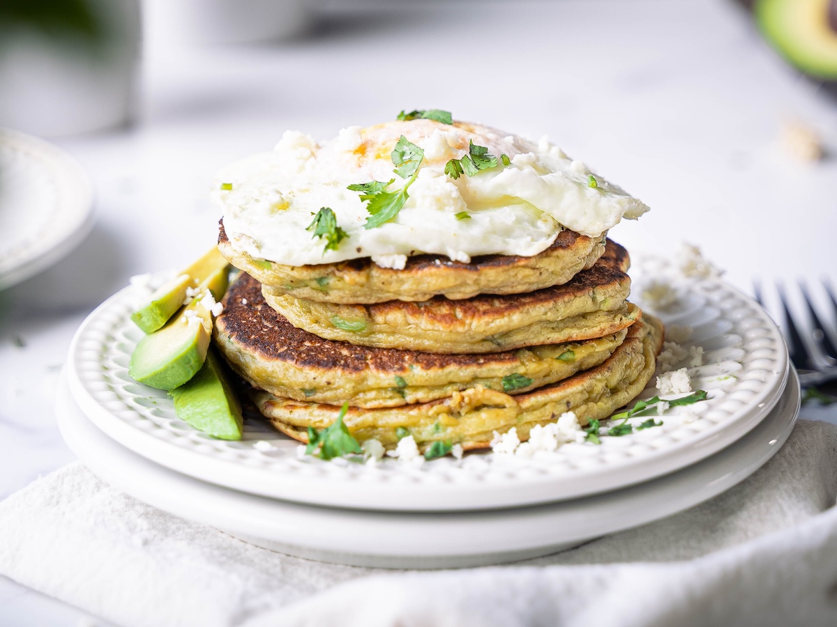 Savory avocado pancakes with avocado slices and egg
