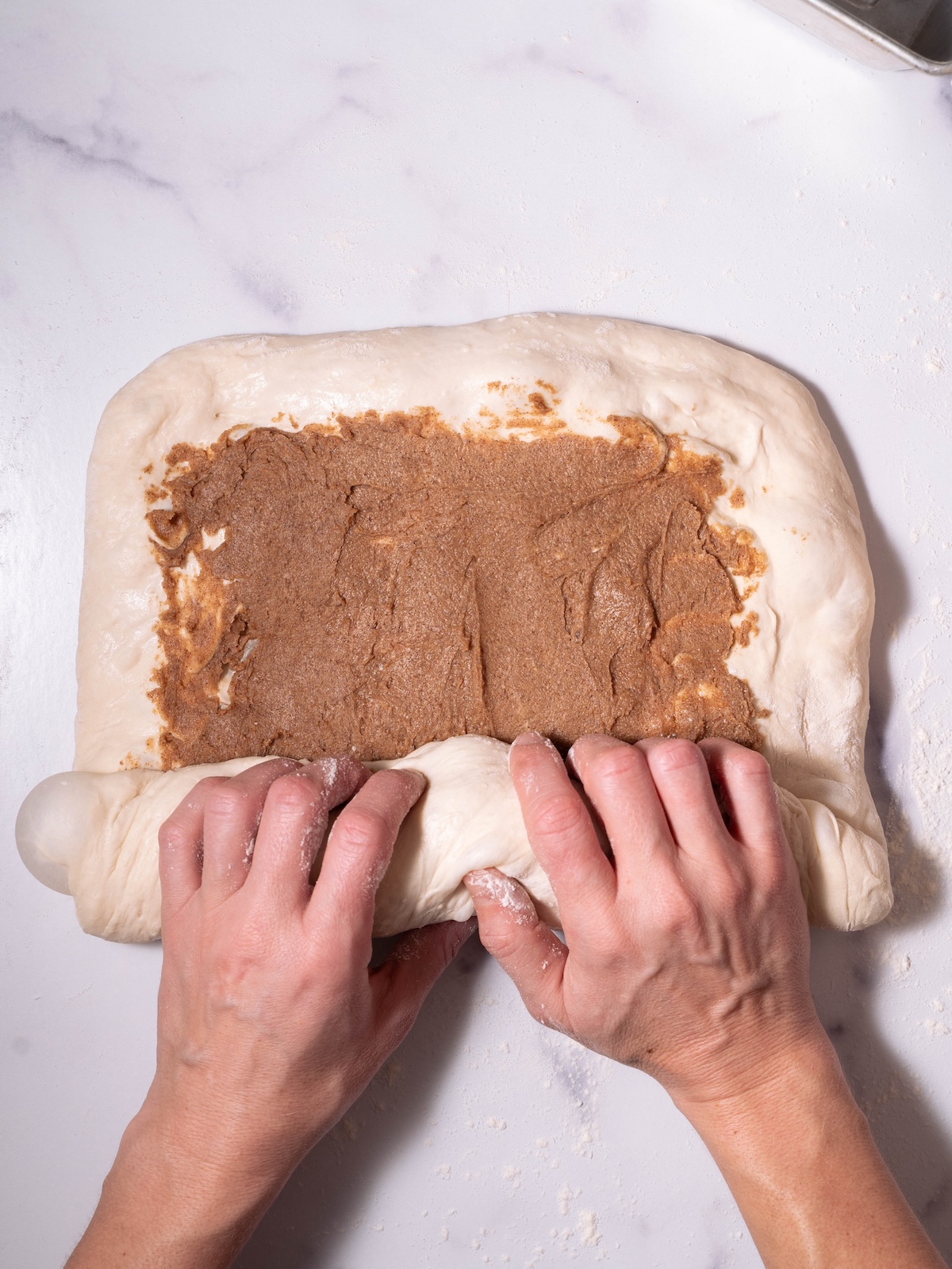 Rolling up sourdough with a cinnamon butter swirl