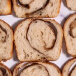 Slices of cinnamon swirl sourdough bread laid flat on a marble counter top