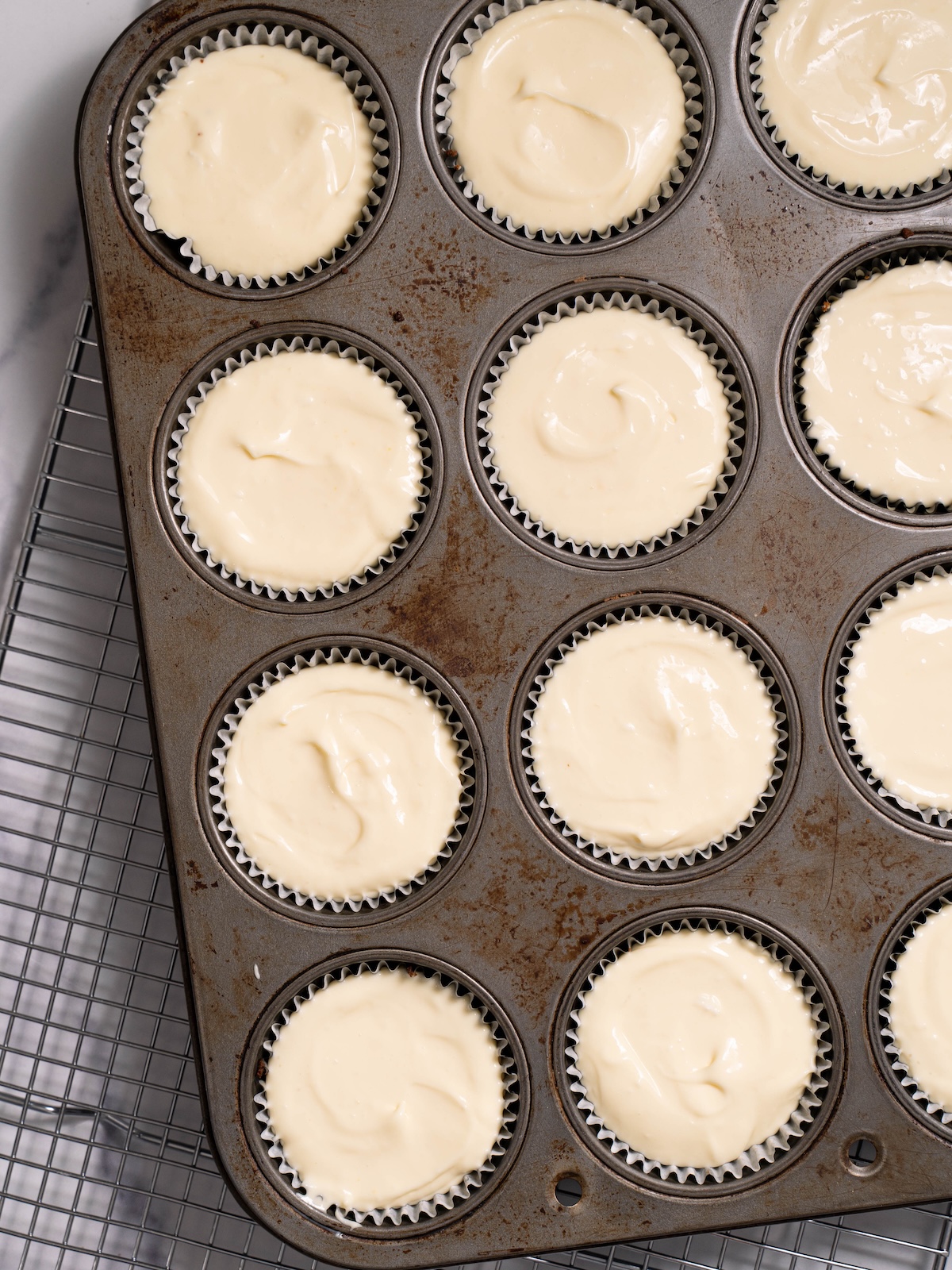 Miniature passionfruit curd cheesecakes before baking