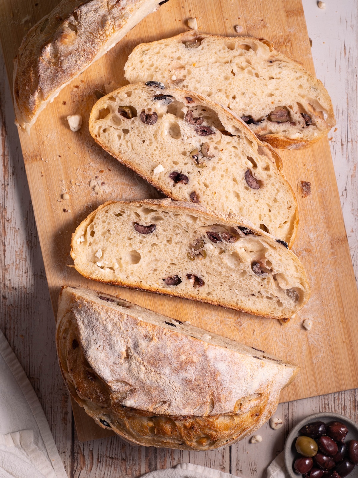 Slices of homemade sourdough bread filled with olives and feta cheese