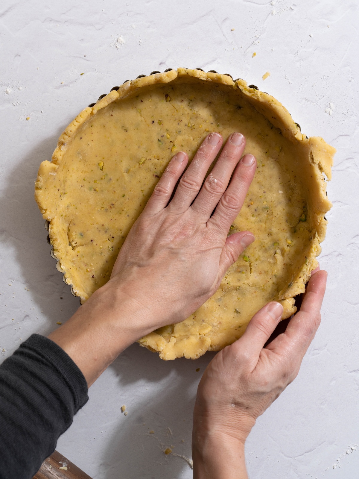 Pressing tart dough into a tart pan