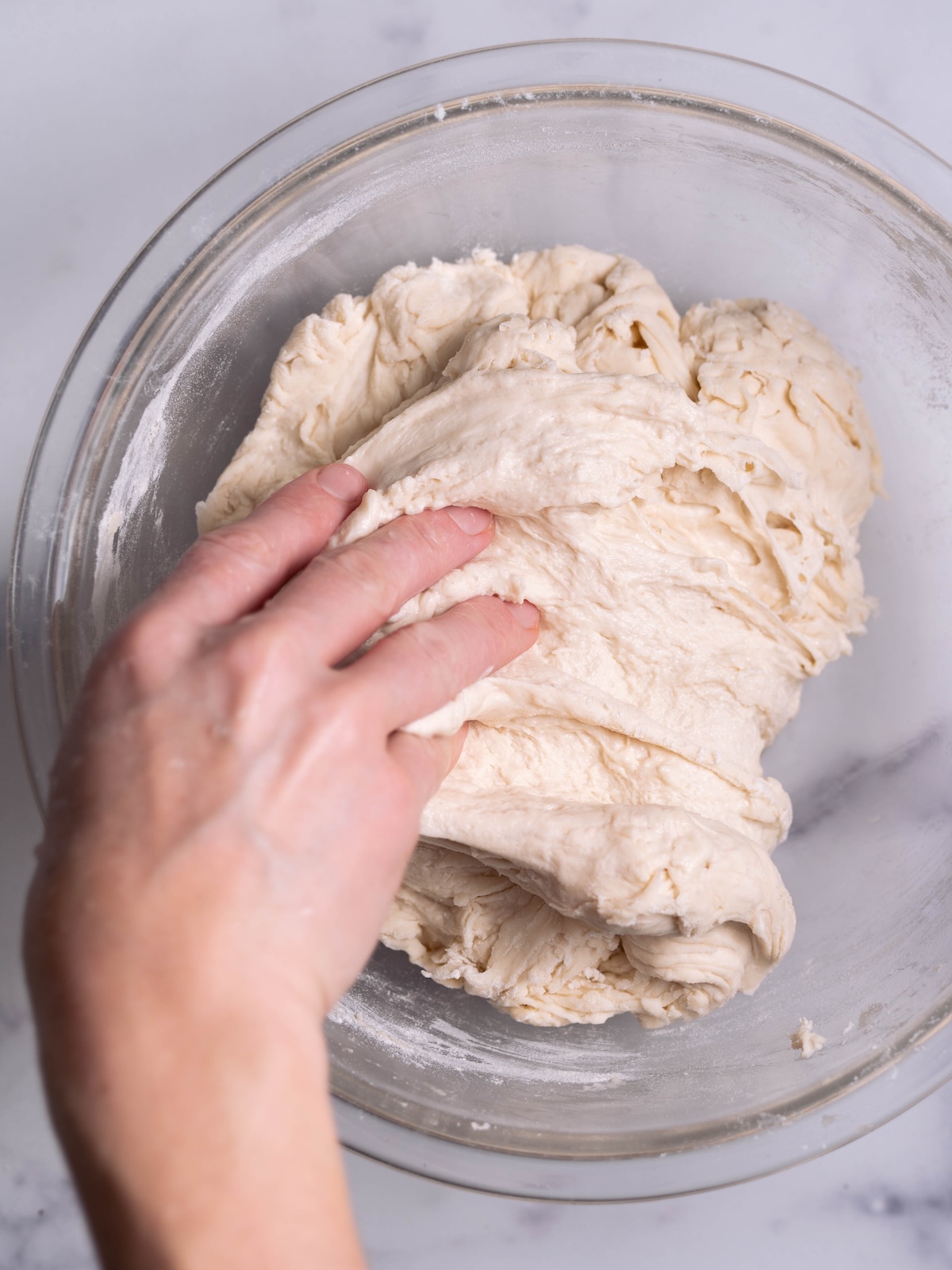 Folding sourdough to create elasticity