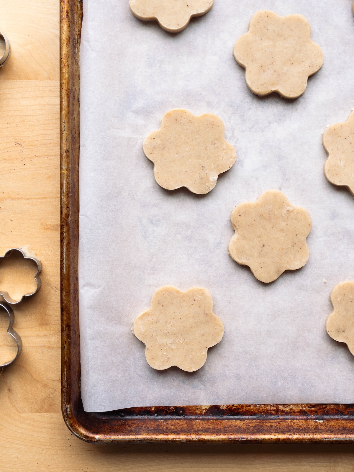 Shortbread cookies cut into flower shapes before baking
