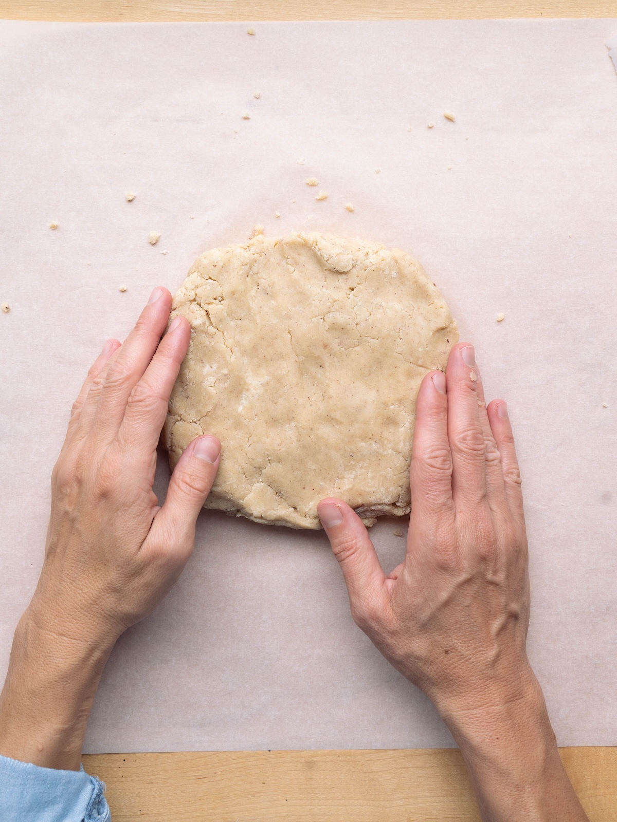 Kneading cookie dough into a round with hands