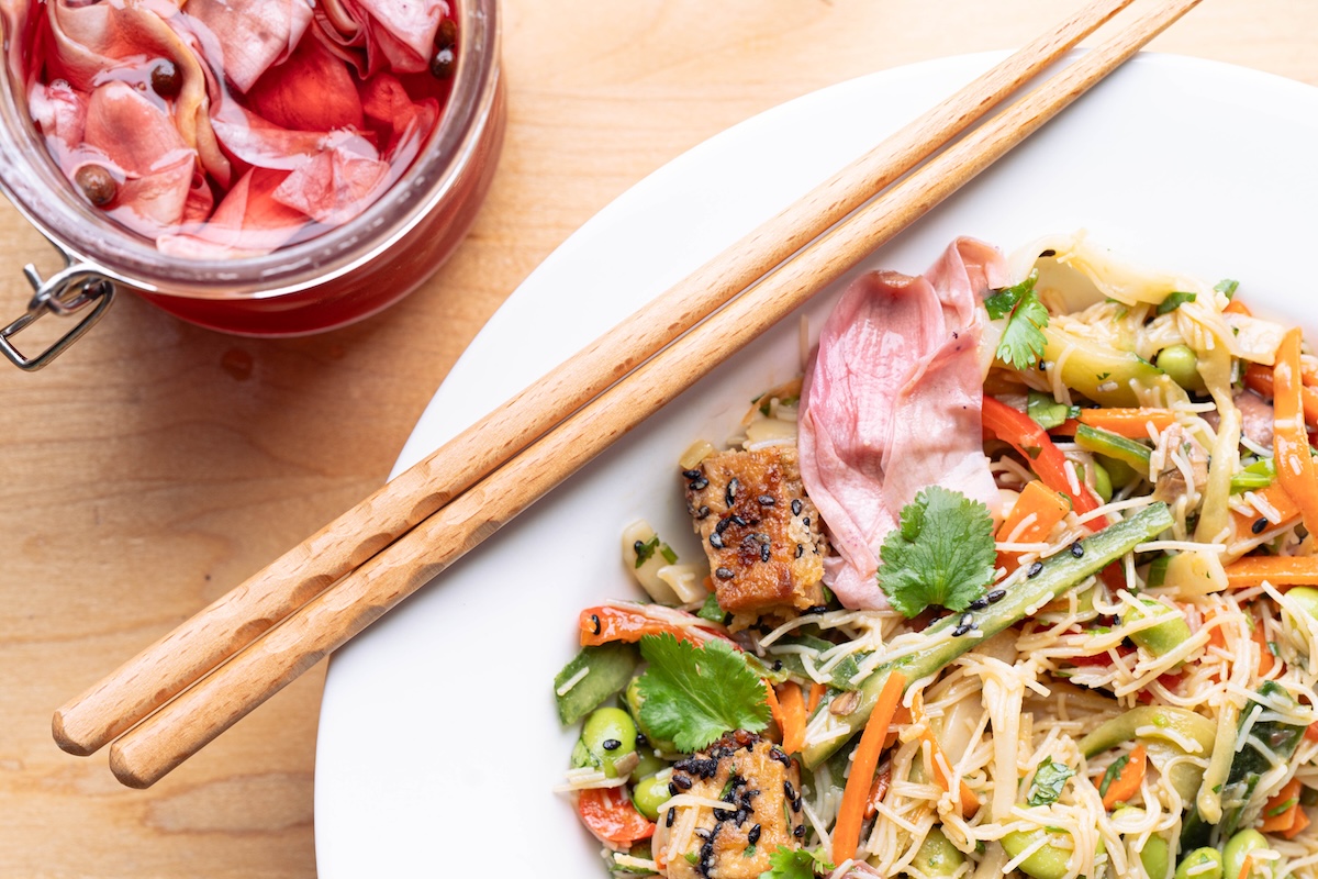 An Asian noodle bowl made with pickled magnolia flower sesame dressing