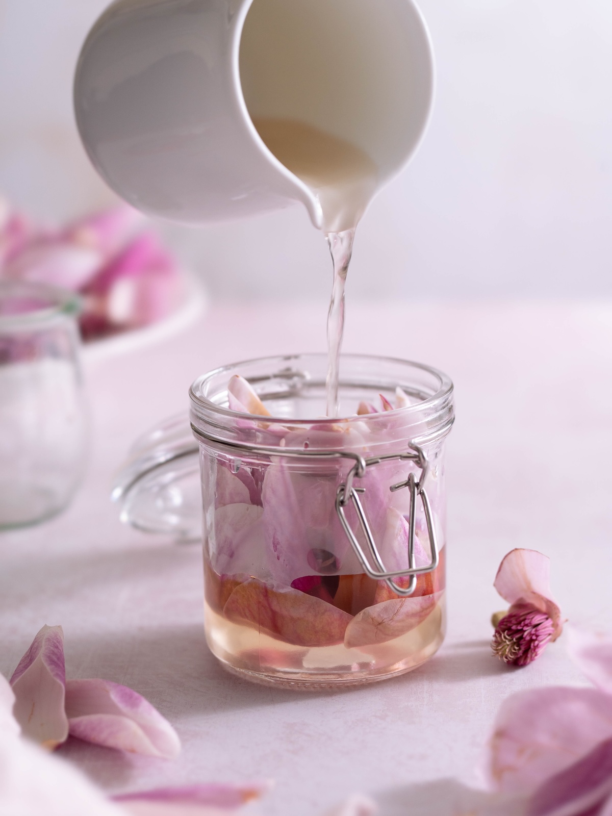 Pouring rice vinegar over magnolia petals
