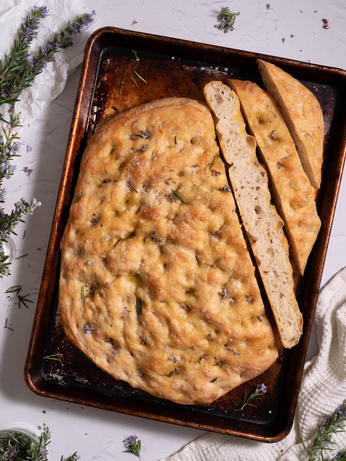 Rosemary flower sourdough discard focaccia sliced to show interior texture
