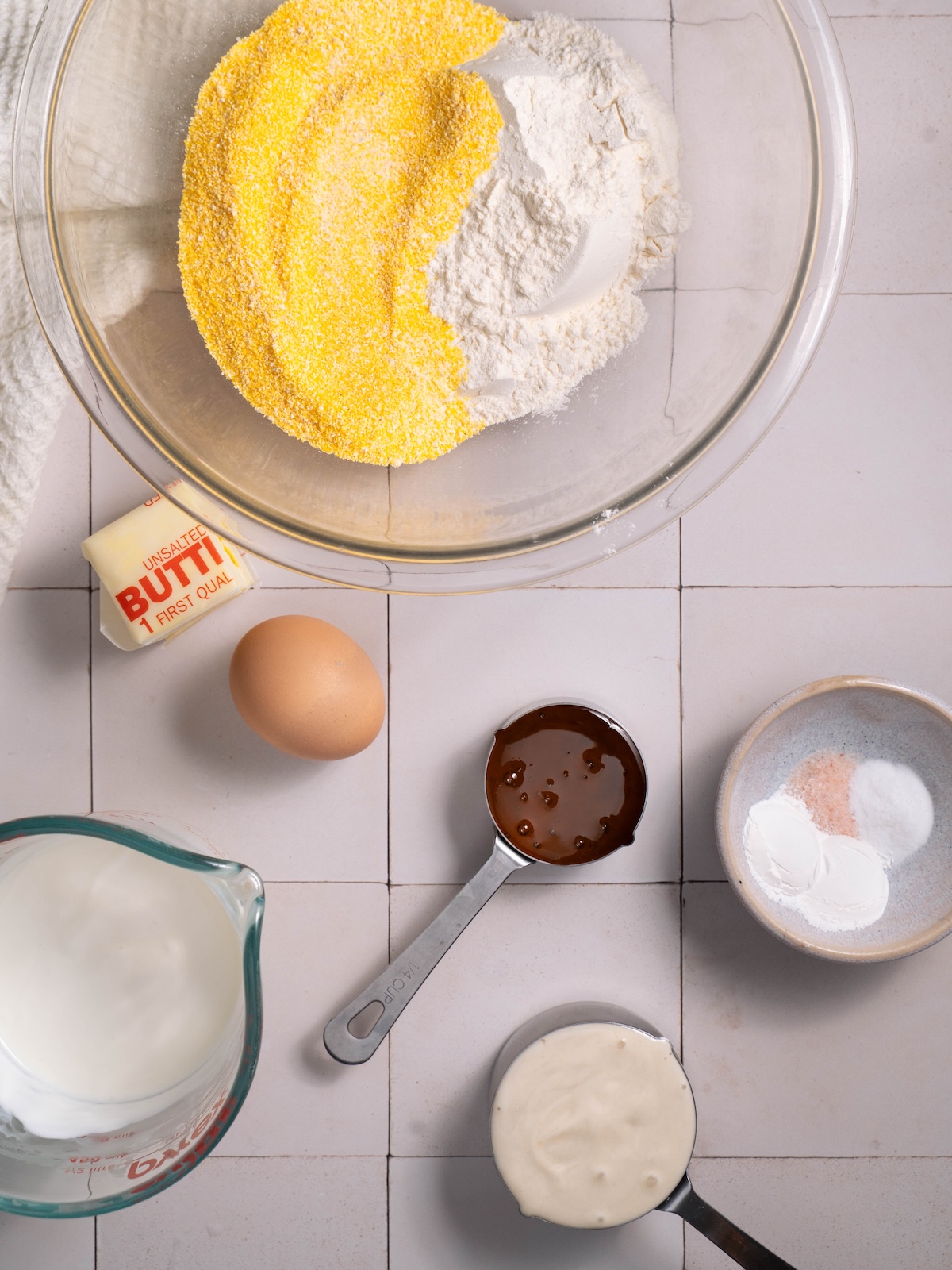 Bowls of ingredients needed to make a batch of cornbread
