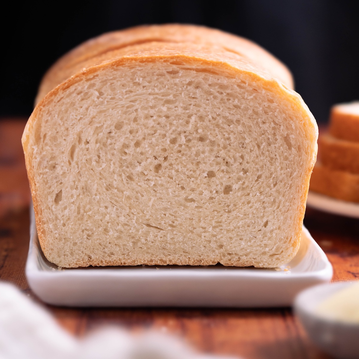 A loaf of sandwich bread sliced in half to show interior texture