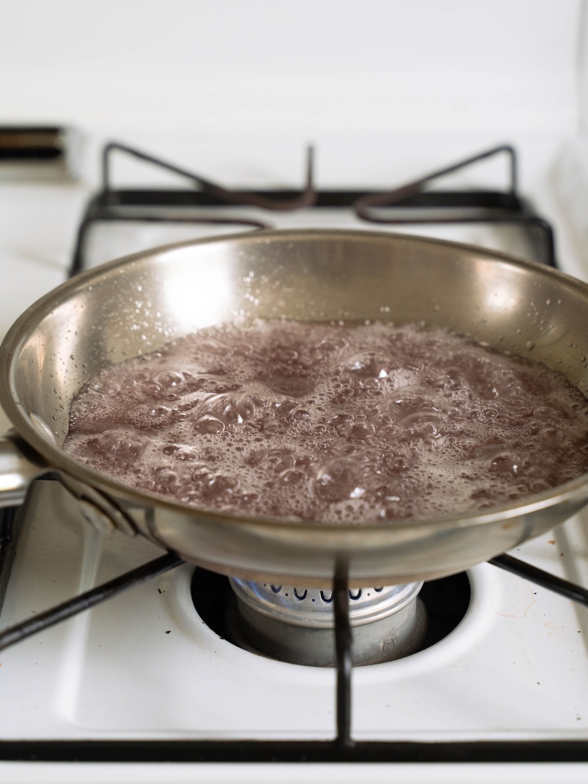 Cooking lilac syrup on the stove