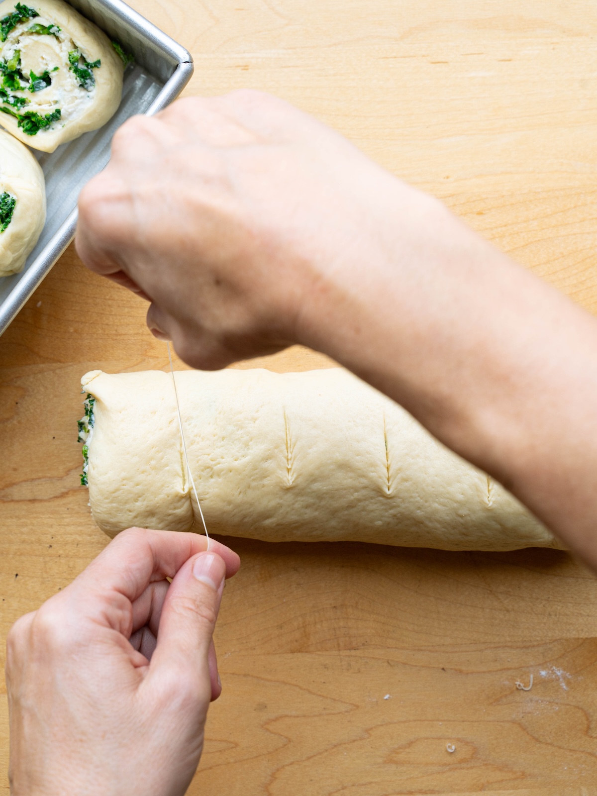 Slicing savory rolls with unflavored dental floss