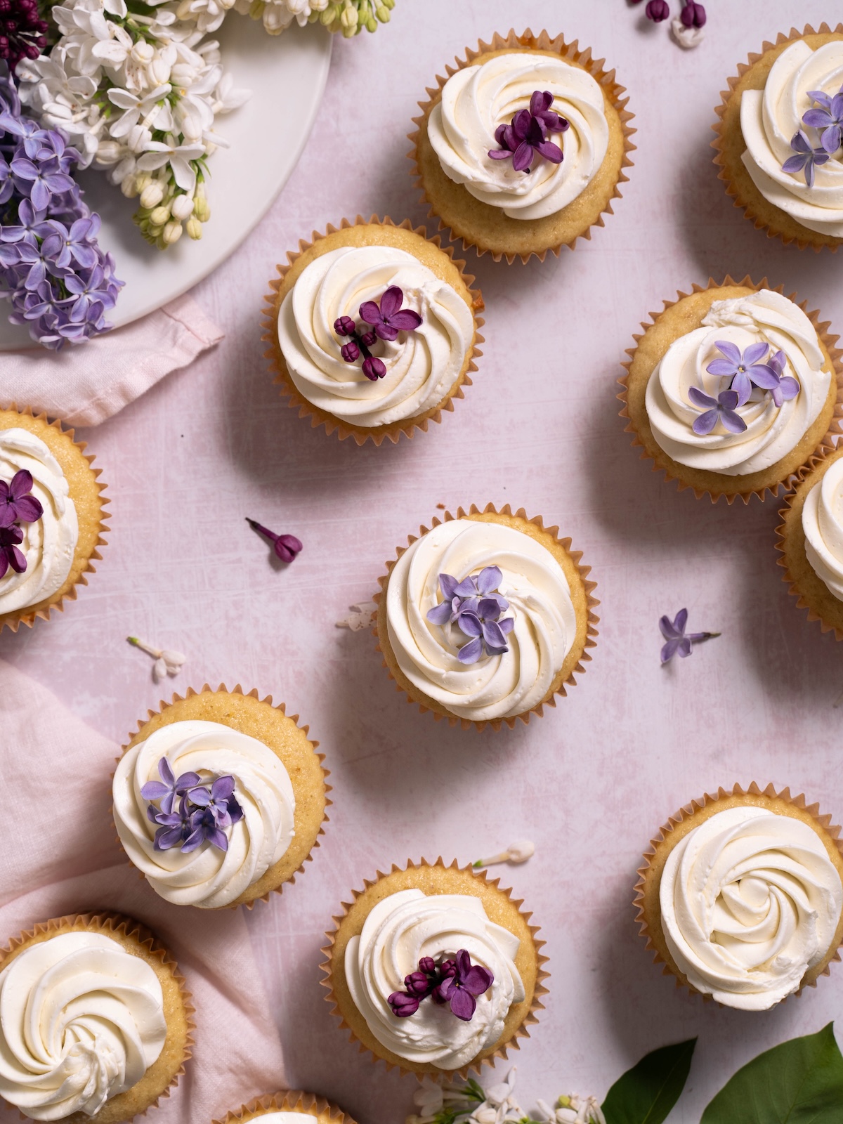 Lilac cupcakes decorated with lilac flowers in various shades of purple and white
