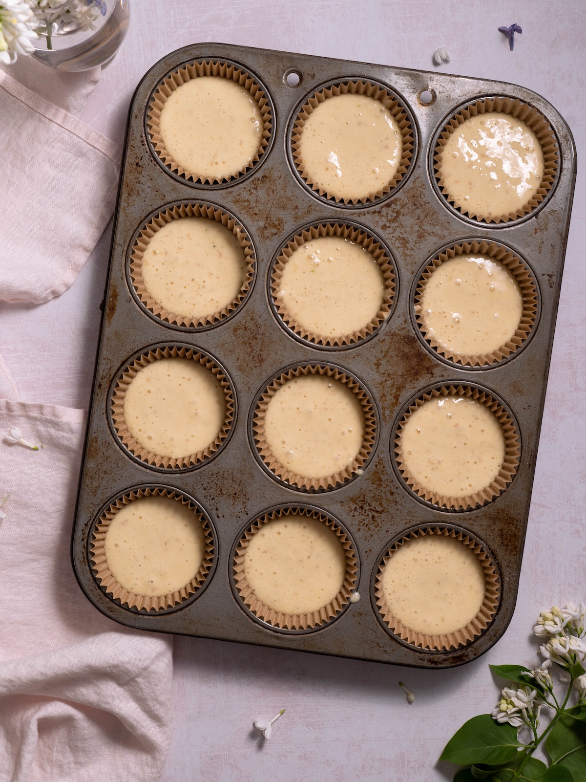Lilac cupcake batter in a cupcake tin before baking