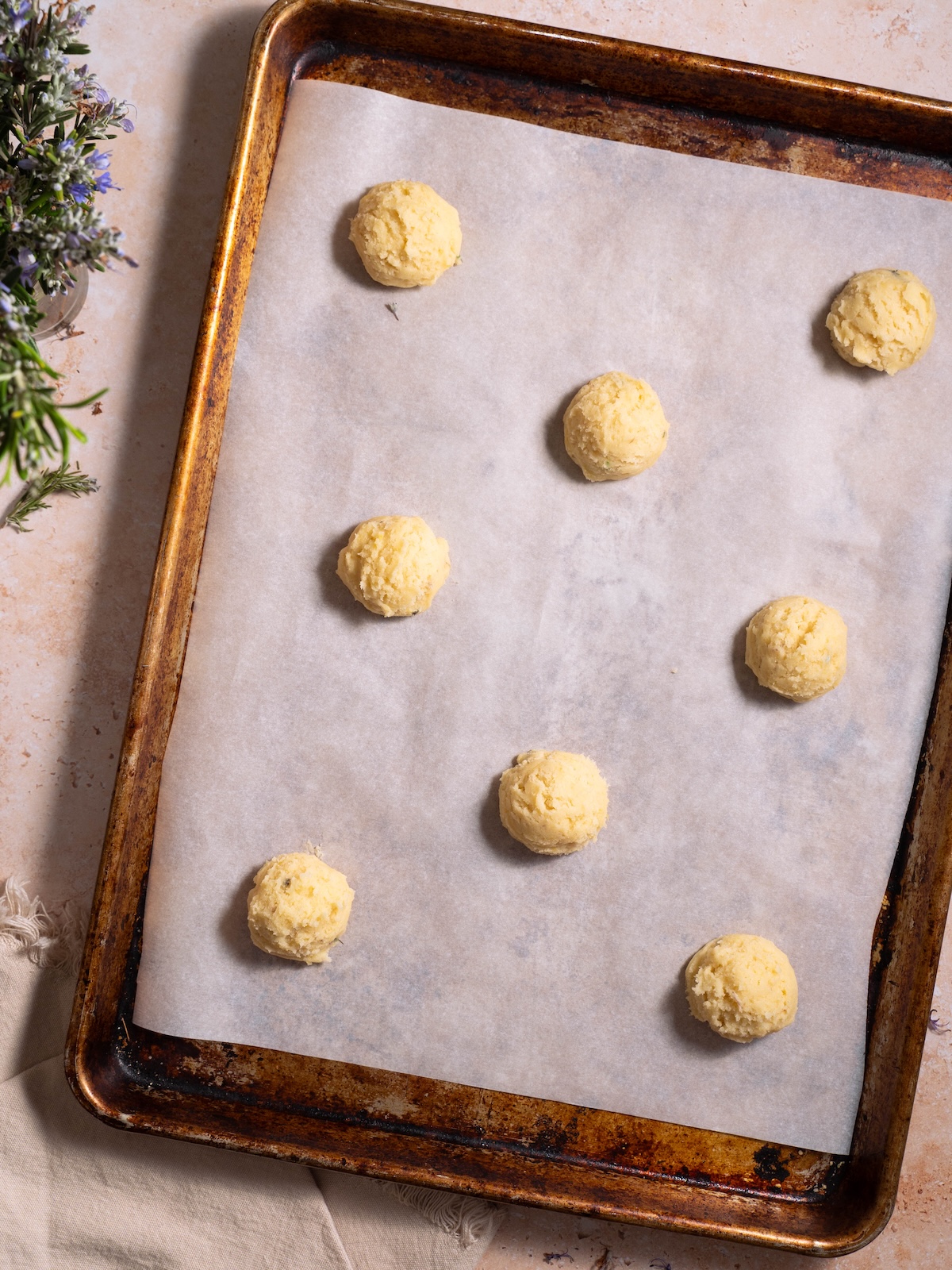 Cookie dough balls on a baking sheet before going into the oven