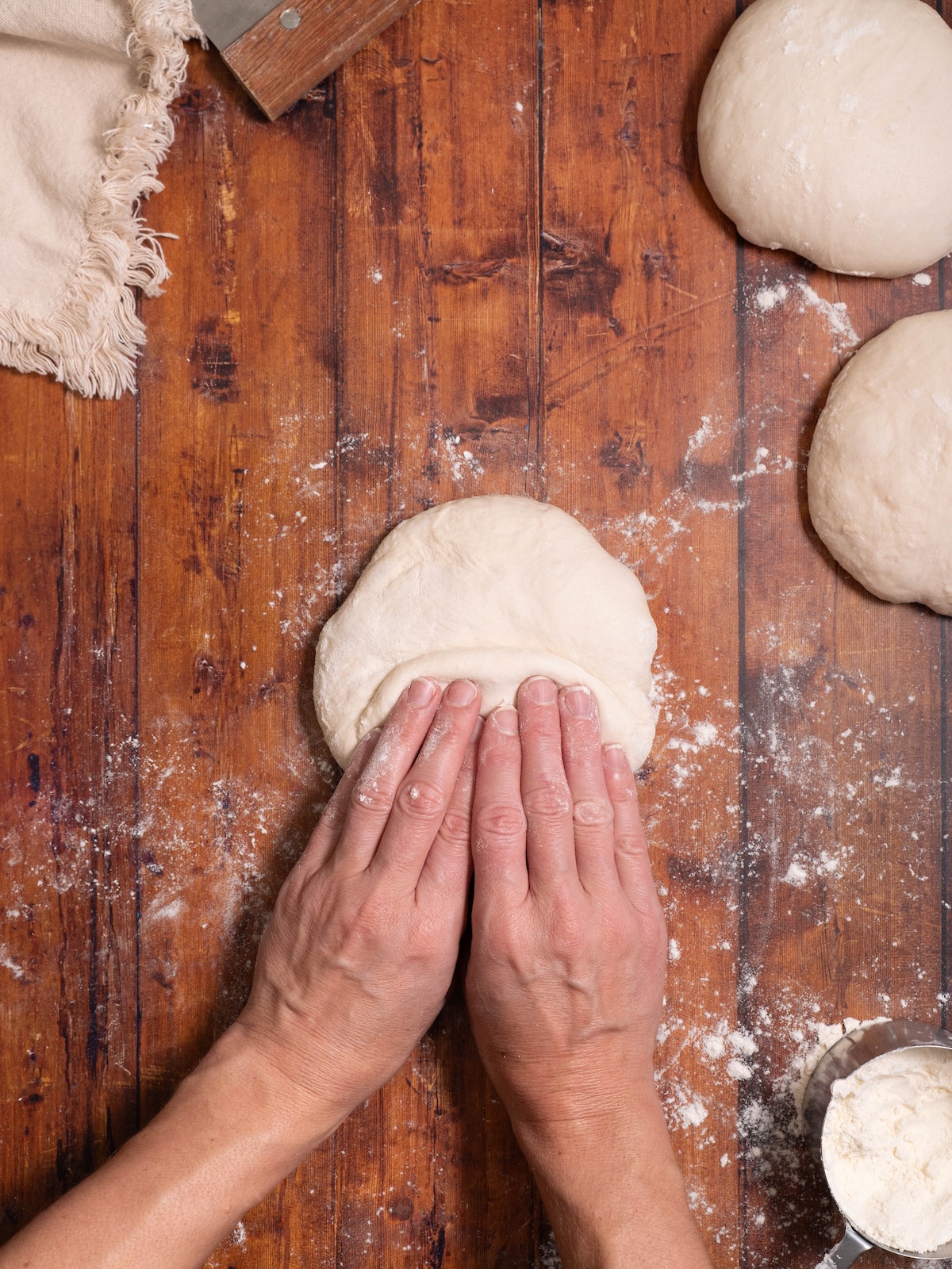 Folding sourdough baguette dough in half