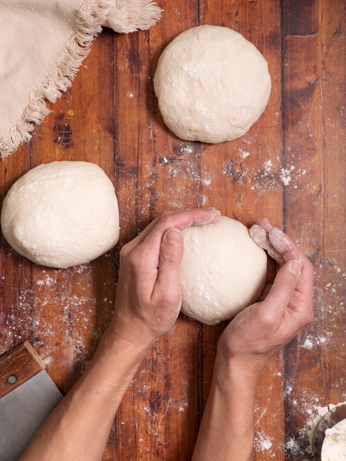 Rolling sourdough bread dough into a ball