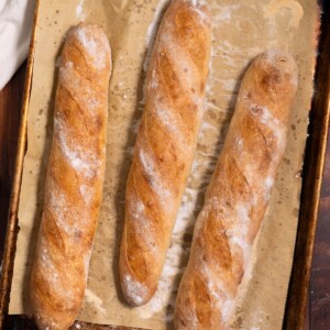 Sourdough demi baguettes on a baking sheet